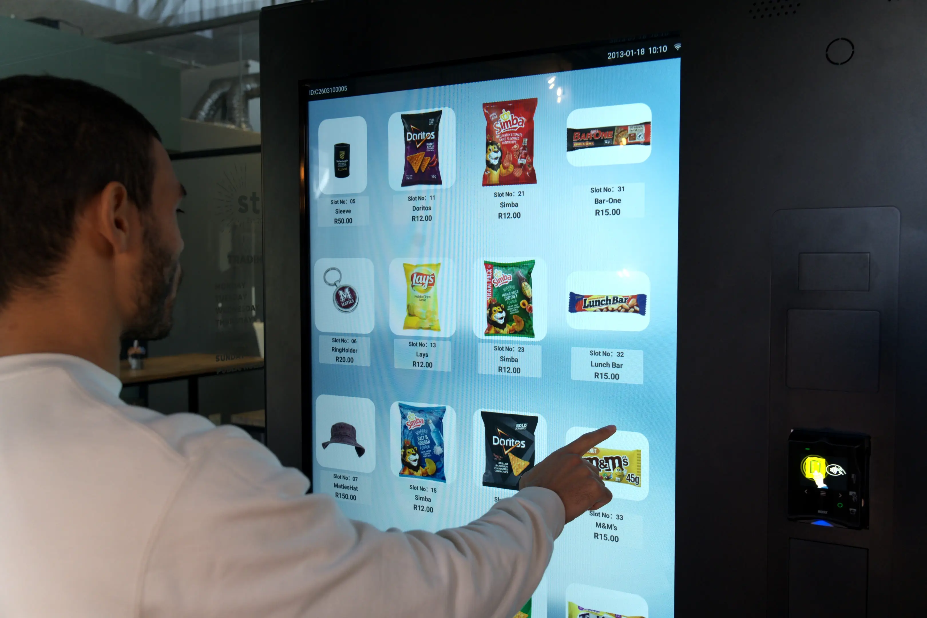 A customer using the full-screen touch display on a Touch Media 4 vending machine