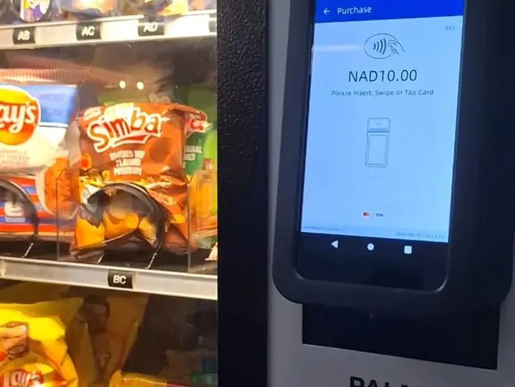 A VendBot P5L card terminal on a Palma vending machine, its screen reading NAD10.00 in Namibian dollars, with a contactless symbol and the prompt to insert, swipe or tap a card