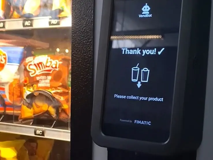 The terminal showing a tick and 'Thank you! Please collect your product', with 'Powered by Finatic' beneath it