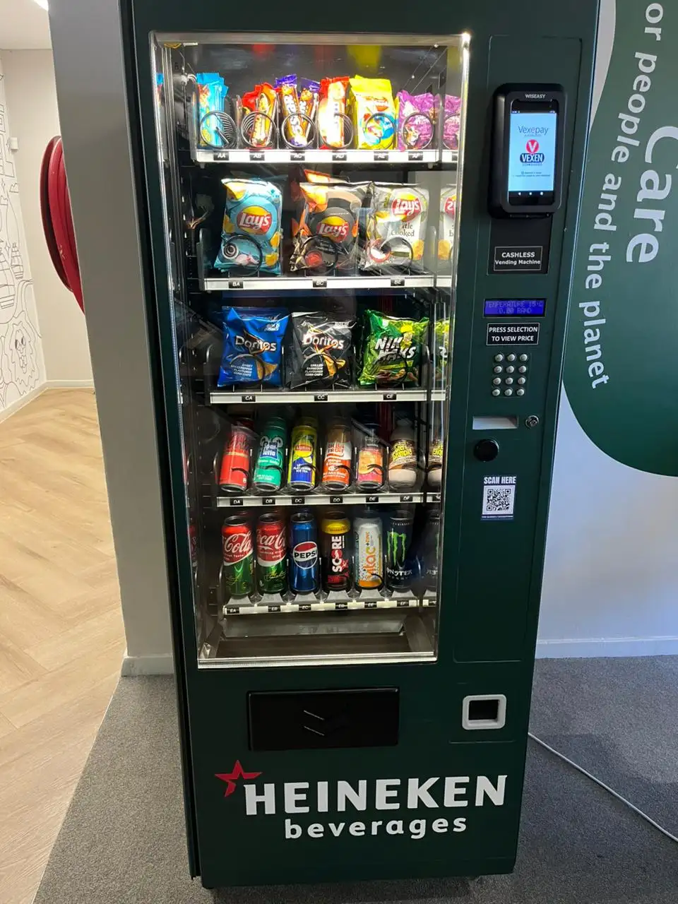A Heineken-branded vending machine stocked with chilled cans and bottles